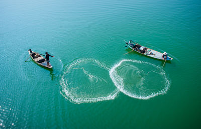 High angle view of fishermen in boats on sea