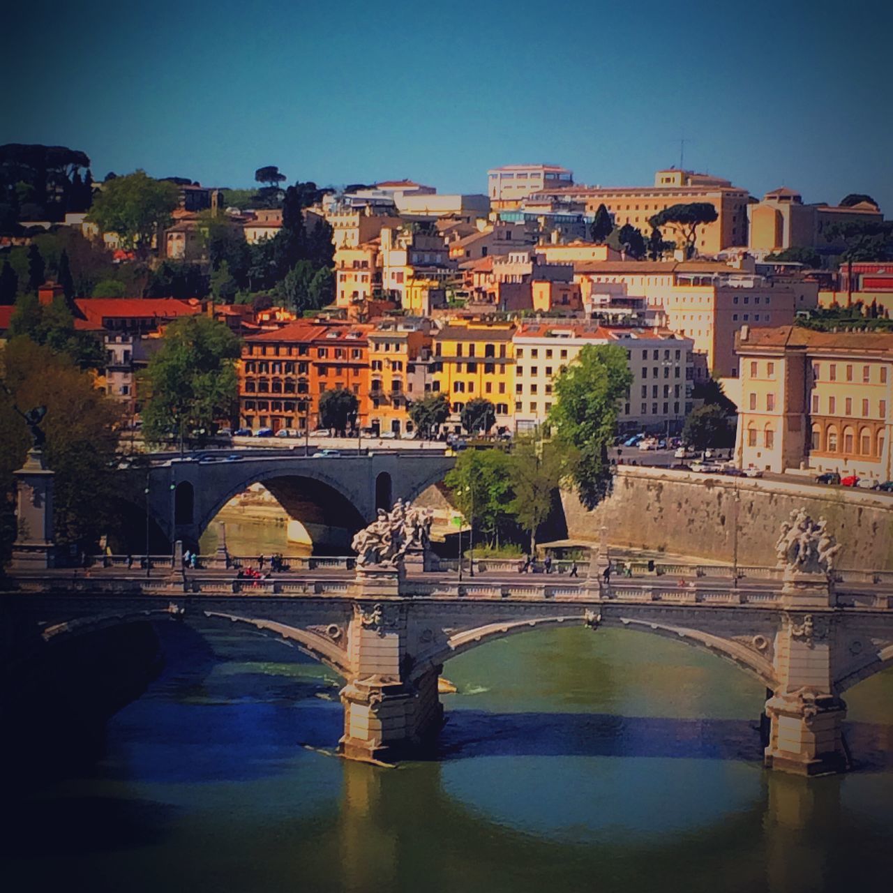 architecture, built structure, water, building exterior, connection, bridge - man made structure, river, arch bridge, bridge, waterfront, arch, clear sky, city, canal, residential building, reflection, residential structure, tree, residential district, cityscape