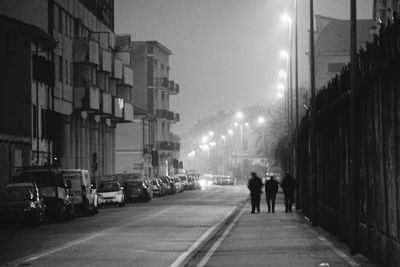 Illuminated city street at night