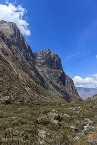 Scenic view of rocky mountains against blue sky