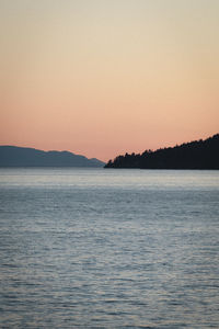 Scenic view of sea against clear sky during sunset