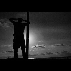 Silhouette of woman standing against sky