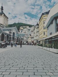 People walking on street amidst buildings in town