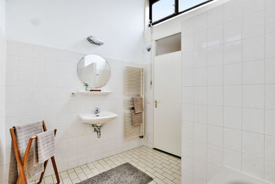 White tile wall in empty bathroom