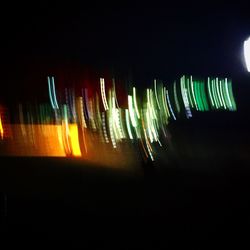 Close-up of illuminated lights against clear sky at night