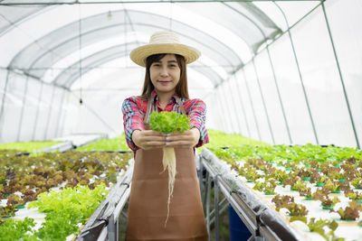 Woman standing in greenhouse