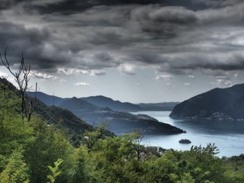 Scenic view of lake and mountains against sky