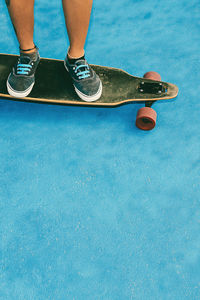 Teenager on skateboard in blue location