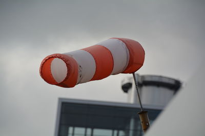 Low angle view of windsock against sky