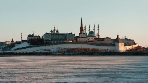 View of buildings in city against clear sky