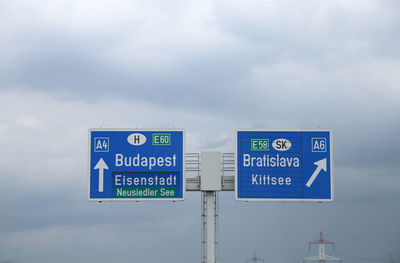 Information sign against sky