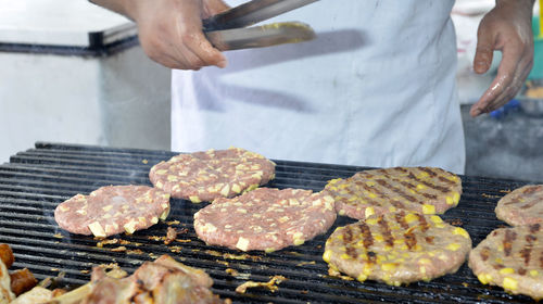 Man preparing food on barbecue grill