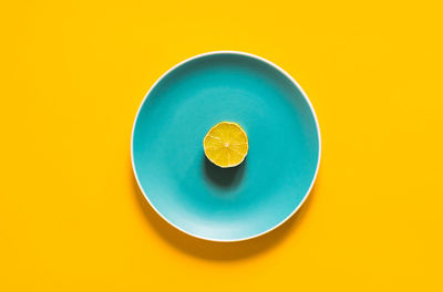 Directly above shot of lemon against blue background