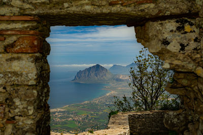 Scenic view of sea and mountains against sky