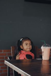 Portrait of a girl sitting on table