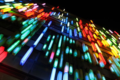 Low angle view of colorful lights at night