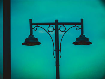 Low angle view of street light against blue sky