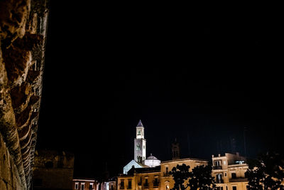 Low angle view of buildings against sky at night