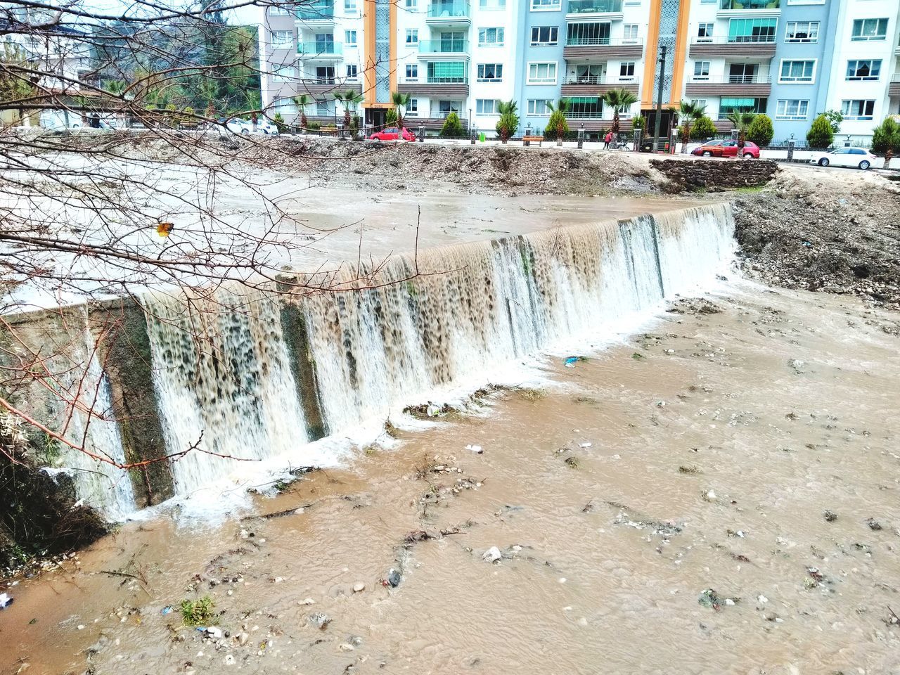 WATER FLOWING IN DAM AGAINST SKY