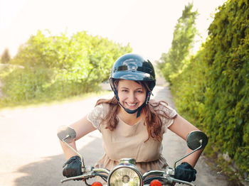 Portrait of smiling woman riding motorcycle