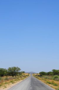 Empty road against clear sky