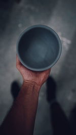 Close-up of hand holding drink against blurred background