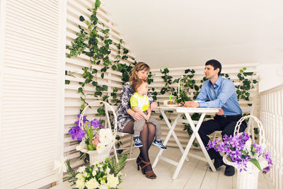 People sitting on potted plant