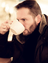 Close-up of mid adult man drinking coffee