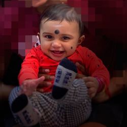 Portrait of smiling boy sitting at home