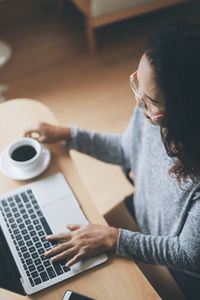 High angle view of woman using laptop at home