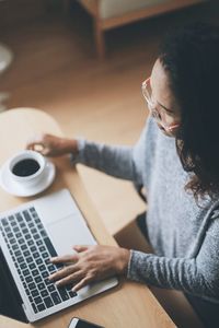 High angle view of woman using laptop at home