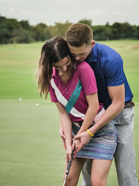 Rear view of couple standing in garden