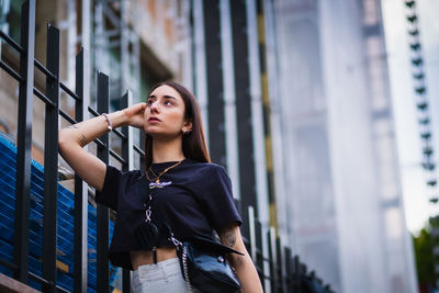 Young woman looking away in city