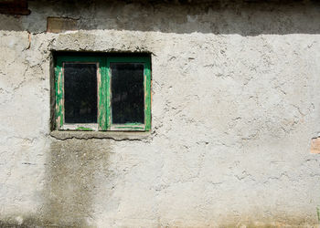 Low angle view of window on wall