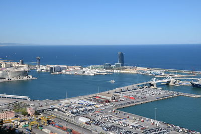 High angle view of city by sea against clear sky
