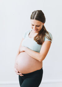 Young woman standing against white background