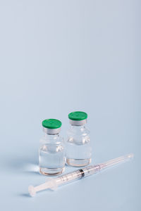 Close-up of wine bottles against white background