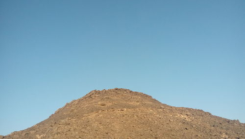 Low angle view of mountain against clear blue sky