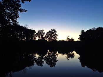 Reflection of trees in calm lake