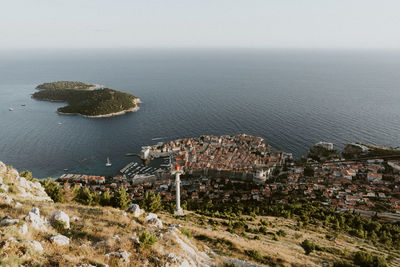 High angle view of sea and buildings against sky