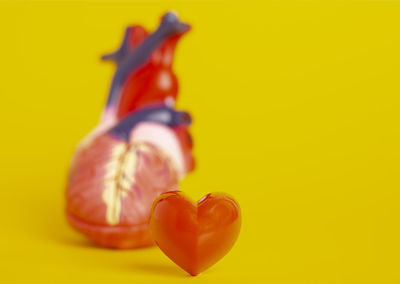 Close-up of heart shape against yellow background