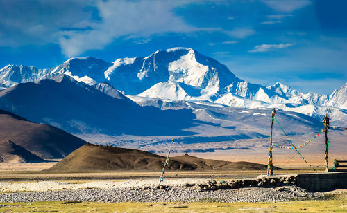 Scenic view of snowcapped mountains against cloudy sky