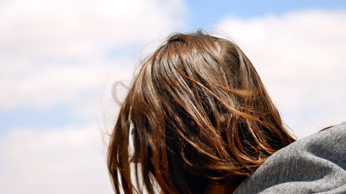 Close-up of young woman against sky