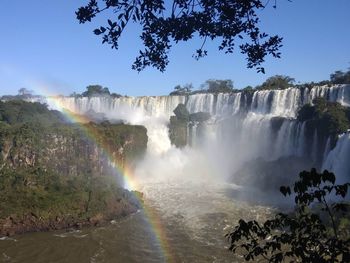 Scenic view of waterfall against sky