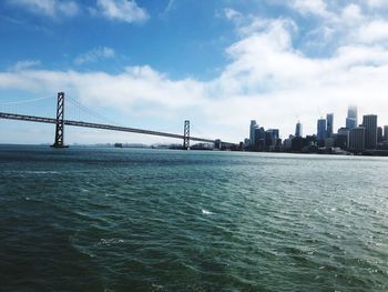 View of suspension bridge with city in background