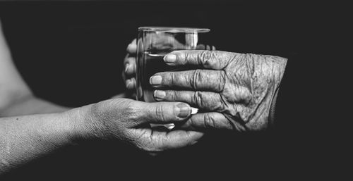 Close-up of man holding glass