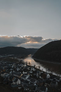 Aerial view of river amidst buildings against sky