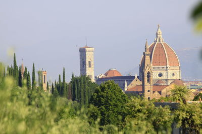 Panoramic view of trees and buildings against sky