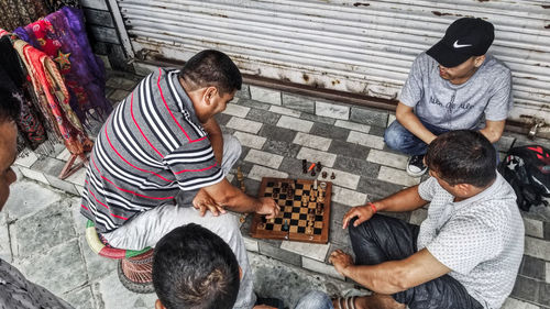 High angle view of men sitting on floor