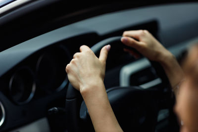 Cropped hand of man driving car